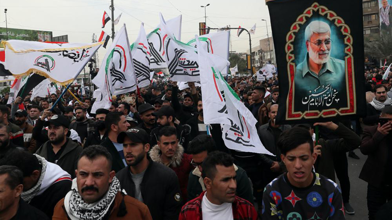 Supporters and members of the Popular Mobilization Forces chant slogans in Baghdad, Iraq, Saturday, Jan. 1, 2022. (Photo: Khalid Mohammed/AP)